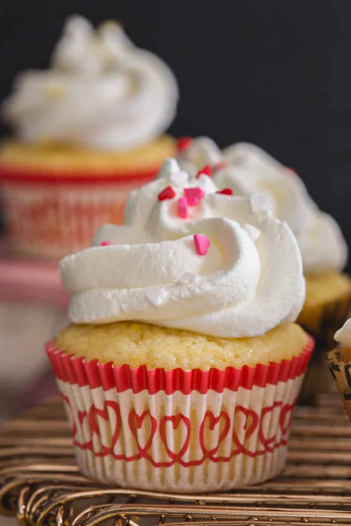 Lemon cupcakes on a wire rack.