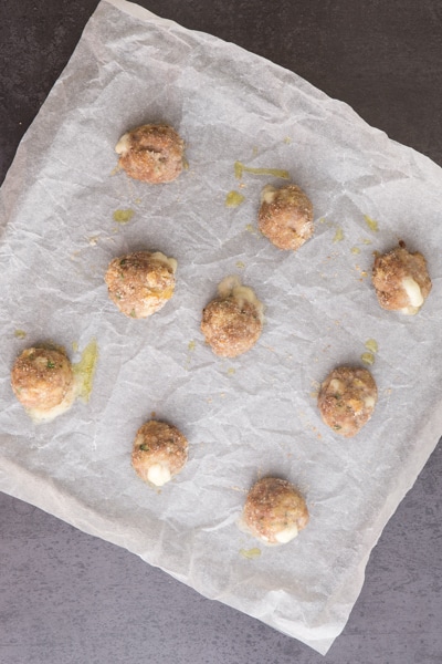 baking the meatballs on a parchment paper cookie sheet