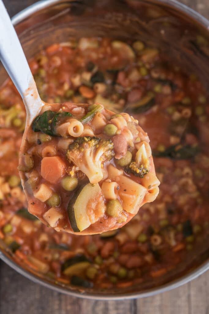 Minestrone in a ladle.