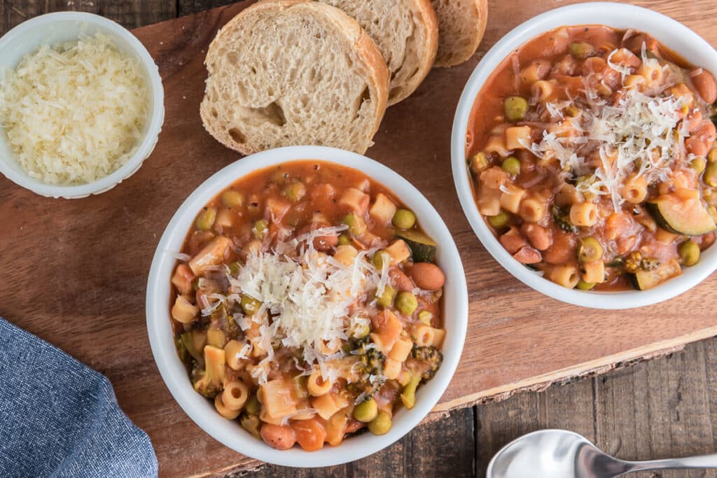 Two bowls of minestrone with parmigiano.