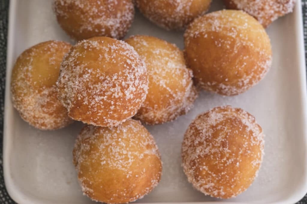 Donut holes on a white plate.