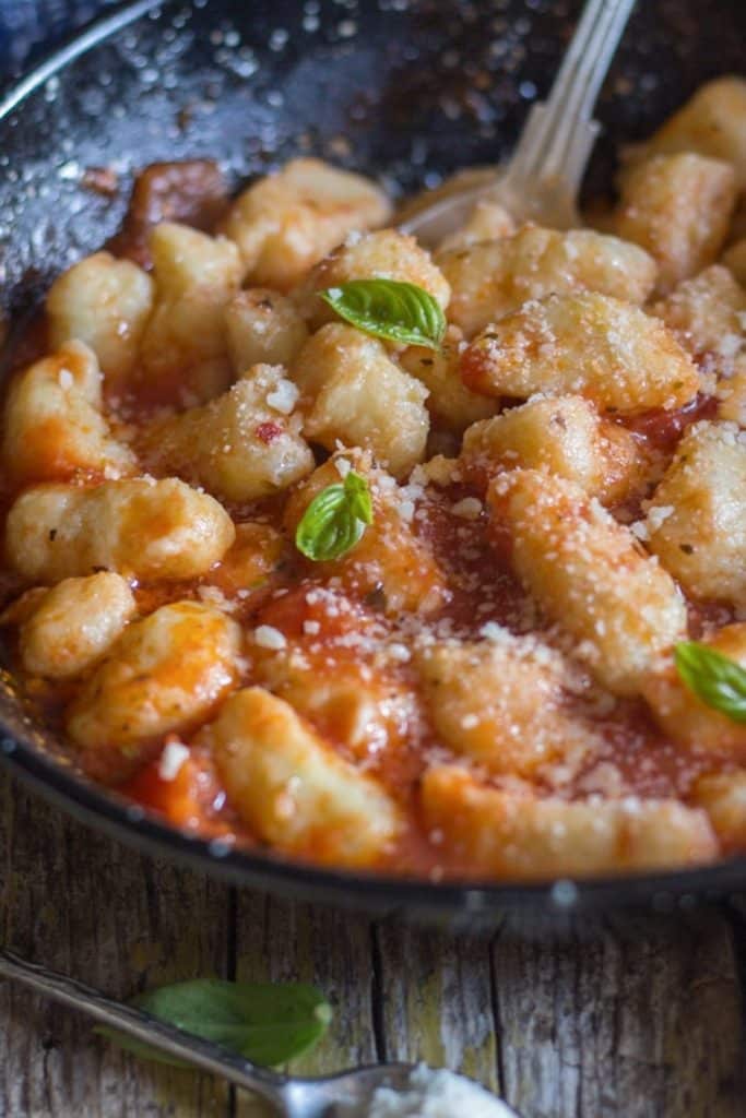Gnocchi with parmesan cheese in a sauce.