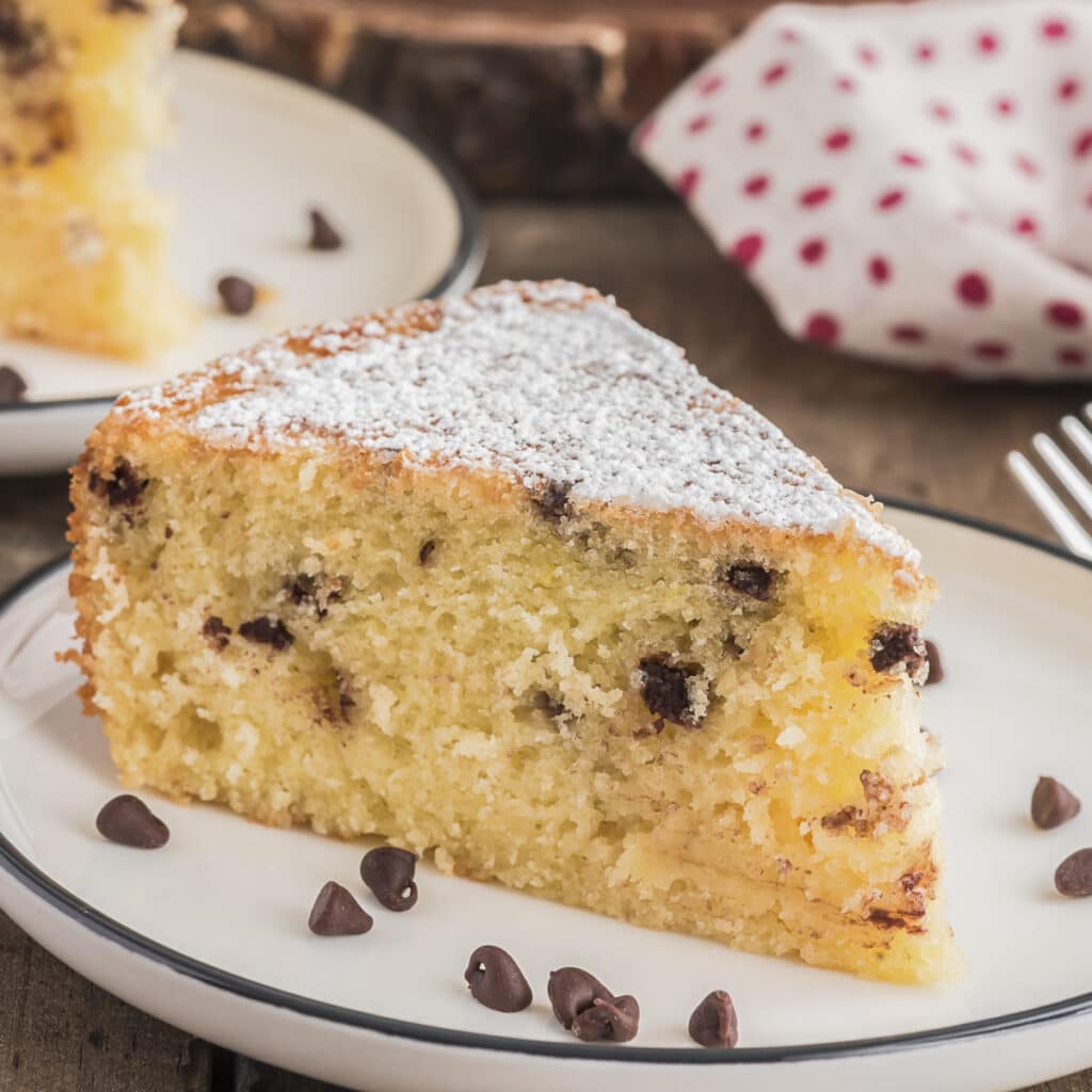 A slice of cake on a white plate.