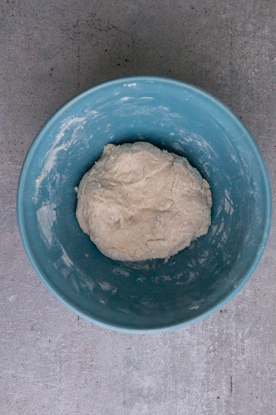 the biga, flour, water & yeast in a blue bowl