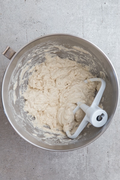 the dough in a silver mixing bowl mixed with flat beaters