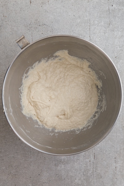 the dough in a silver bowl kneaded