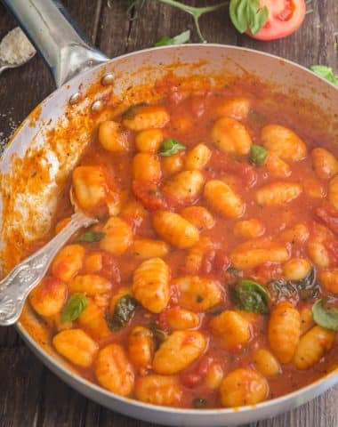 Sauce and gnocchi in a silver pan.