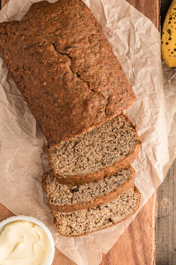 Banana bread with three slices cut.