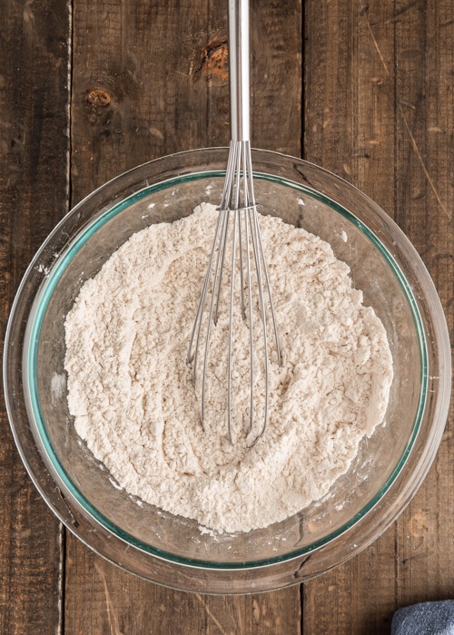 The dry ingredients whisked in a glass bowl.