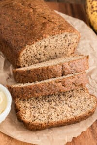 Banana bread with three slices cut.