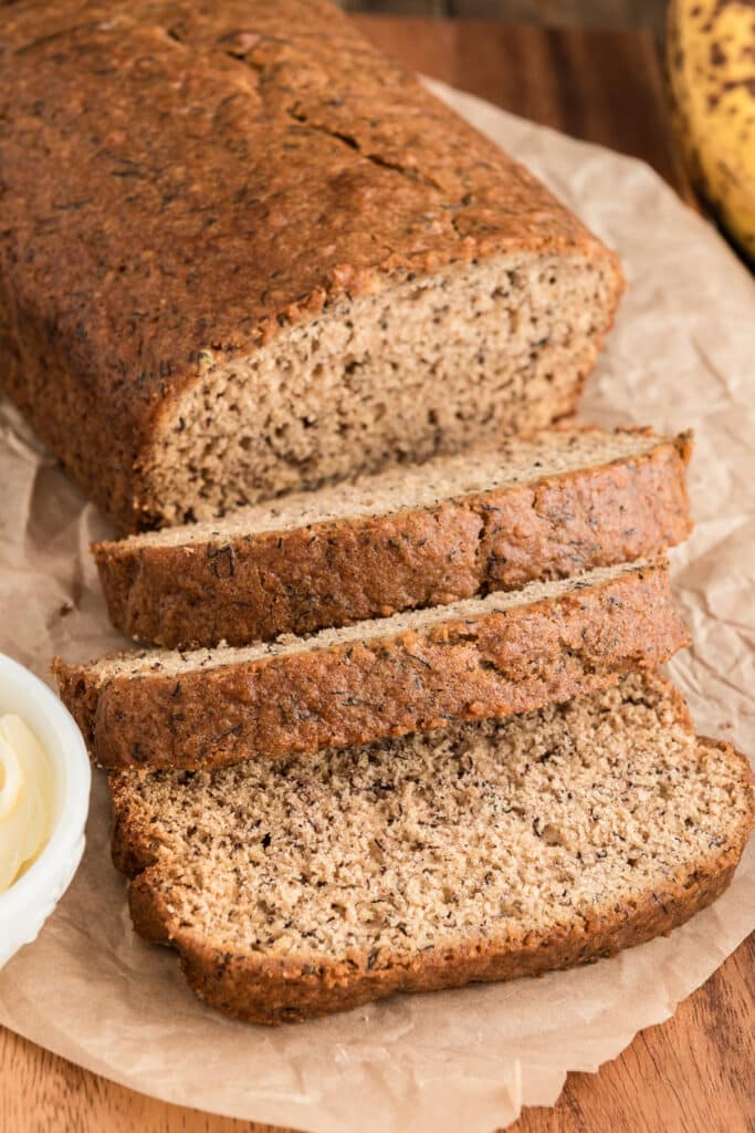 Banana bread with three slices cut.