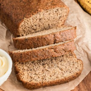 Banana bread with three slices cut.