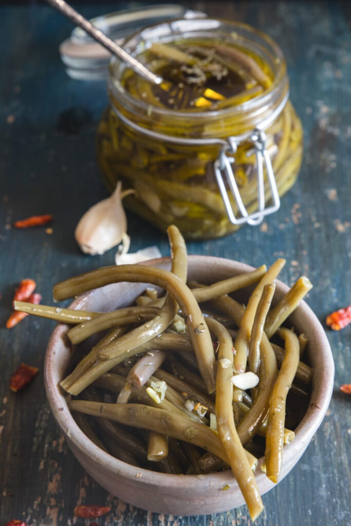 Green beans in a grey bowl and in a jar.