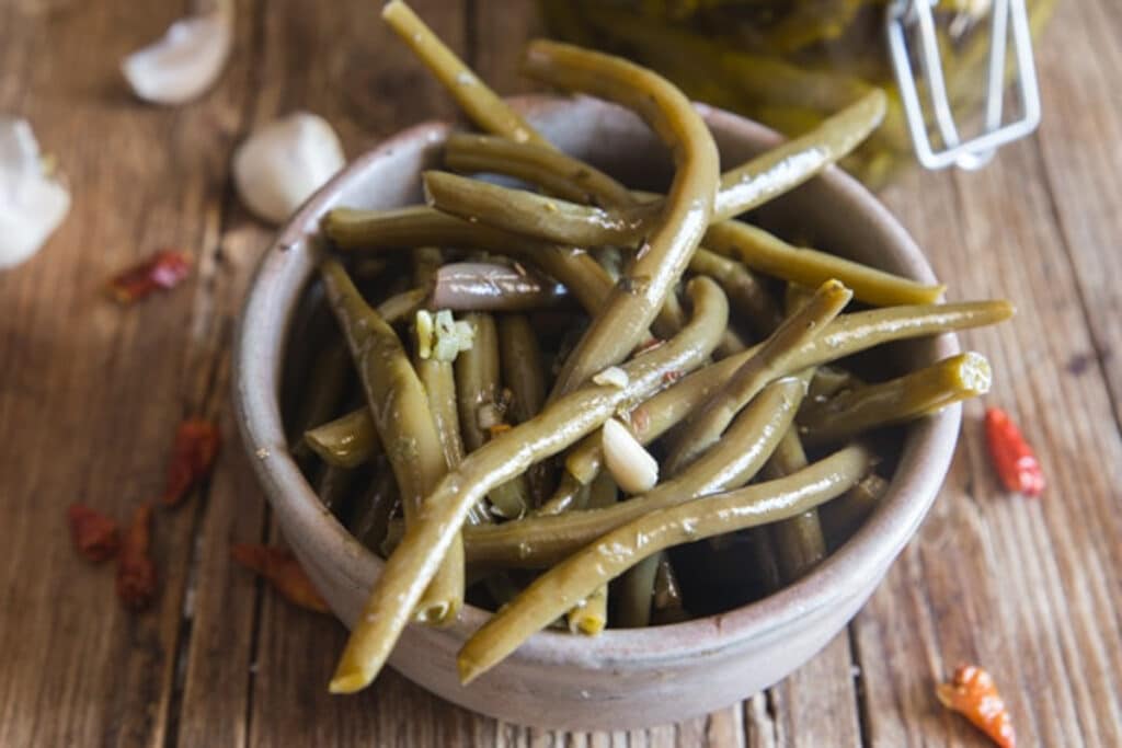 Green beans in a grey bowl.