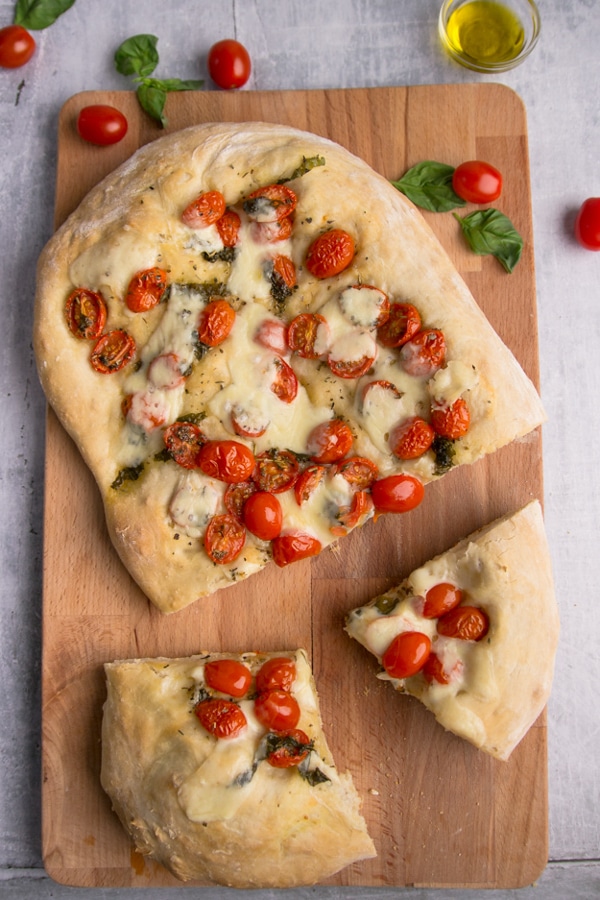 baked pizza on a wooden board