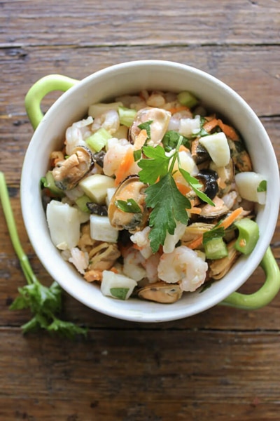 Seafood salad in a white bowl.