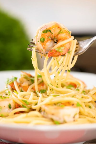 Pasta and shrimp on a fork.