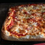 Pizza on a wire rack.