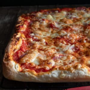 Pizza on a wire rack.