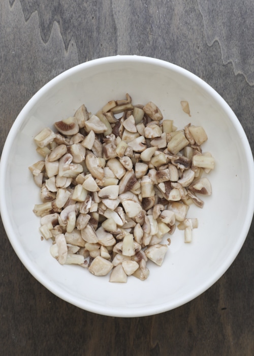 Drained mushrooms in a white bowl.