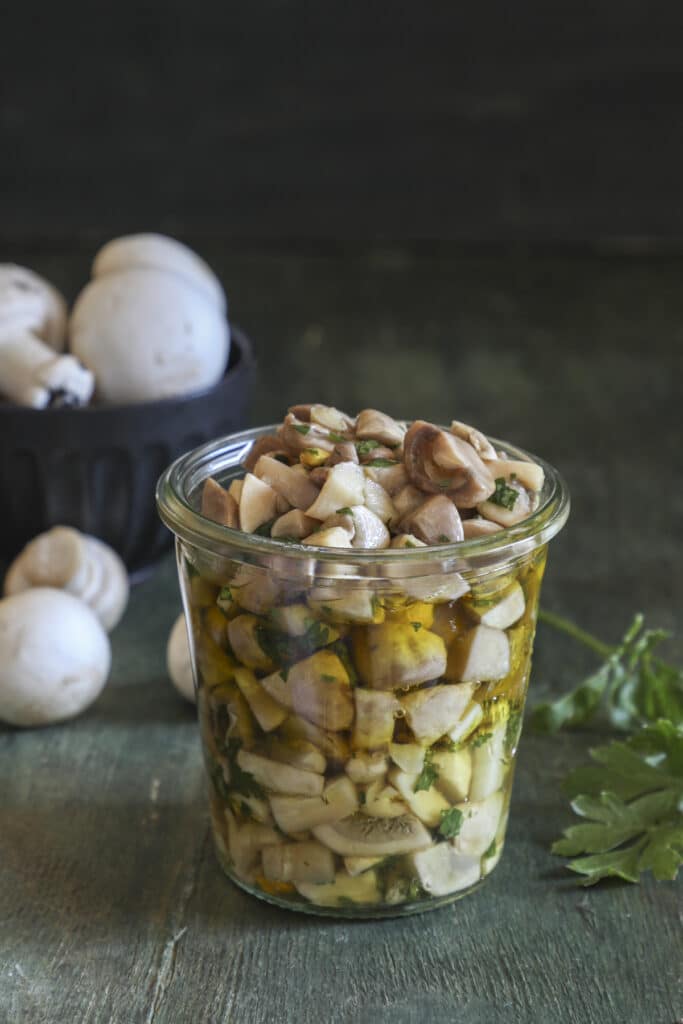 Marinated mushrooms in a glass jar.