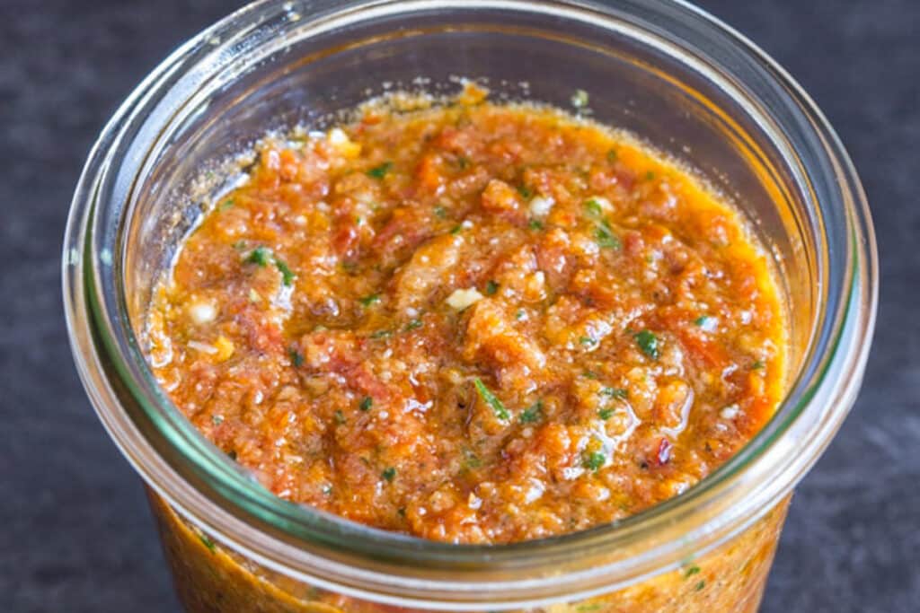 Tomato pesto in a glass jar.