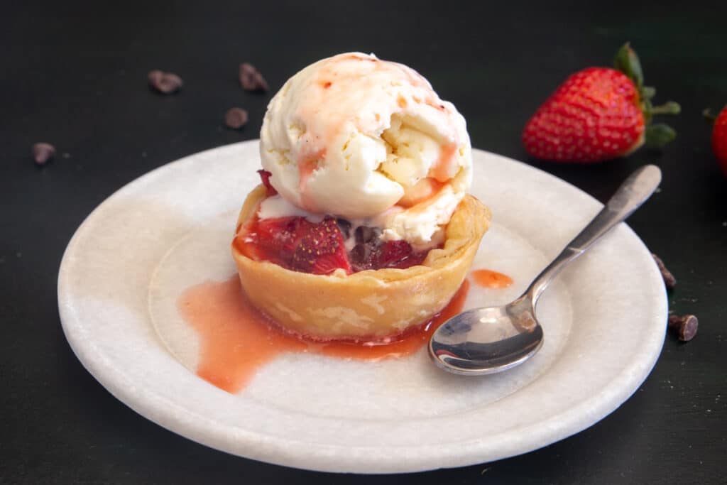 Tart on a plate with a scoop of ice cream.