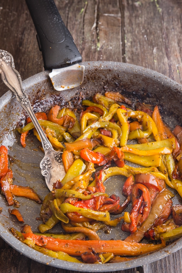 fried peppers in a frying pan with a fork