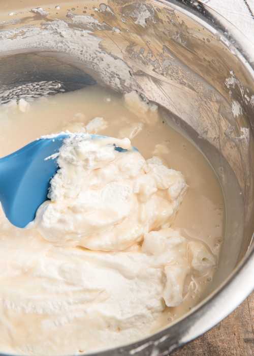 Mixing the sweetened condensed milk and cream together.