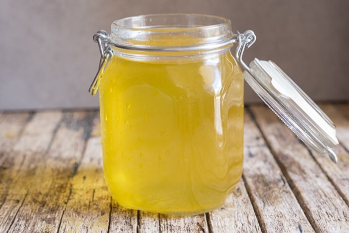 Strained limoncello in a glass jar.
