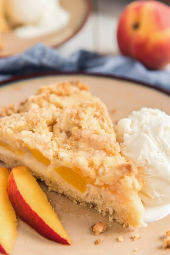 A slice of crumb cake on a cream plate.