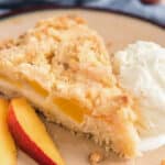 A slice of crumb cake on a cream plate.