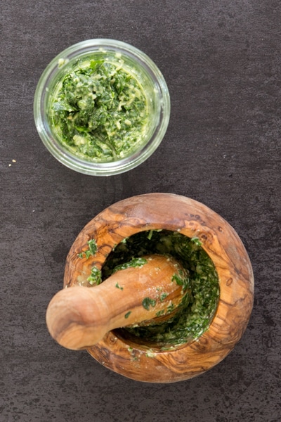 mixing to make the pesto in a mortar & pestle
