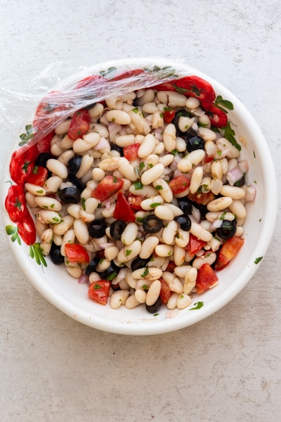 bean salad mixed together ready to be refrigerated
