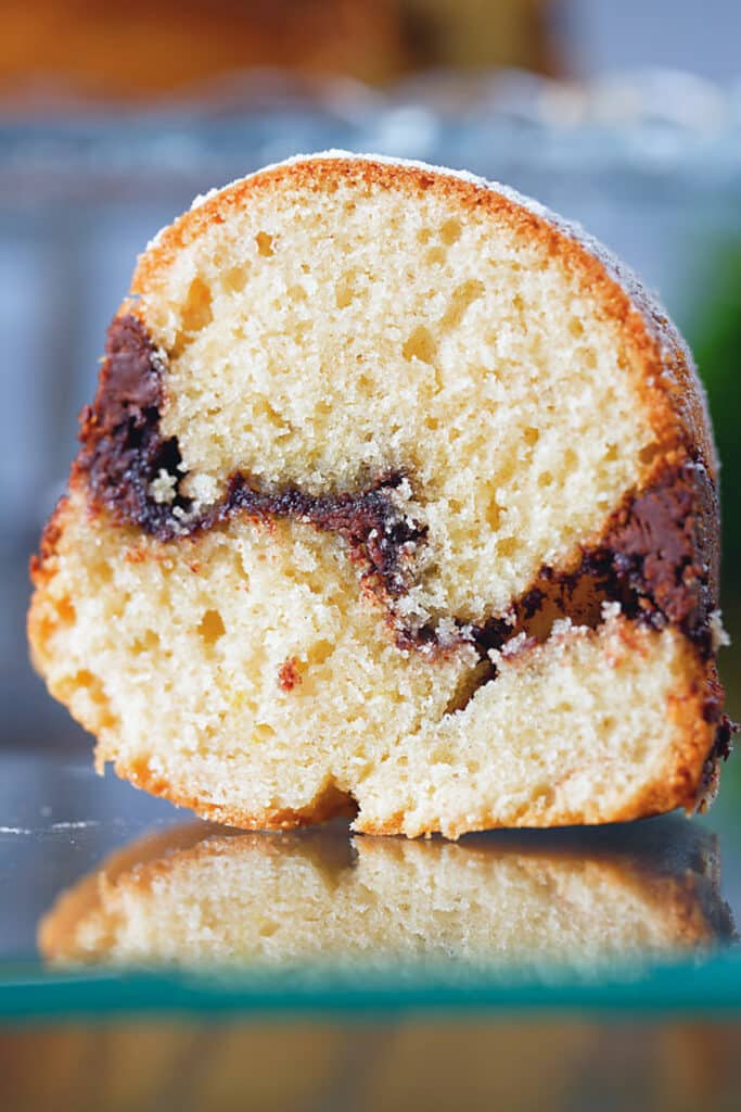 A slice of cake on a glass plate.