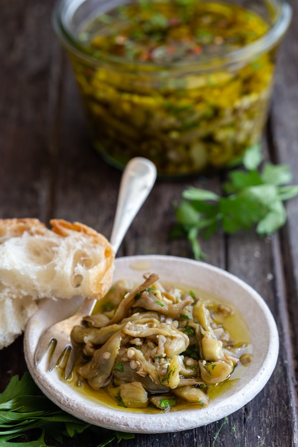pickled eggplant in a white dish and in a jar