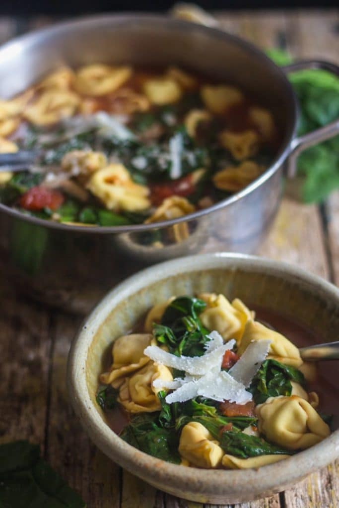 Tortellini soup in a pot and in a bowl.