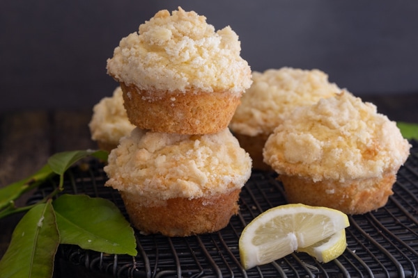 lemon muffins on a black wire rack with 2 stacked