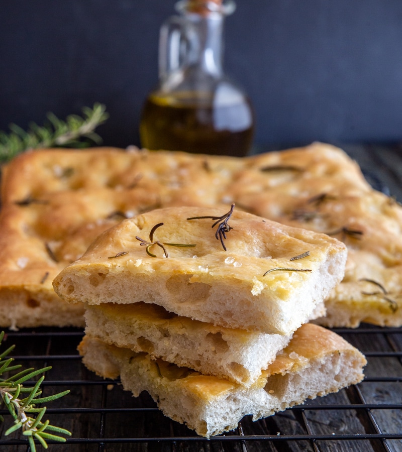 3 slices of focaccia on top of each other with remaining on a wire rack