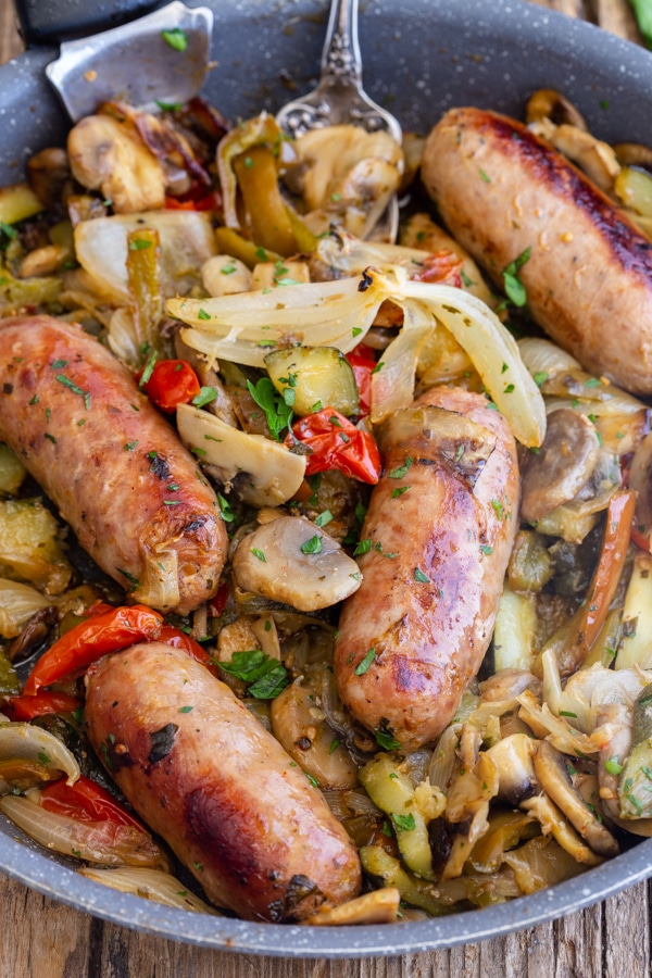 4 sausages with vegetables in a pan
