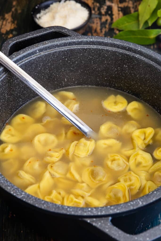 Tortellini in a black pot.