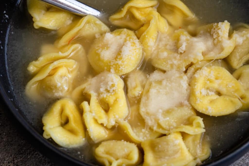 Tortellini with parmigiano in a bowl.