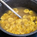 Tortellini in a black pot.