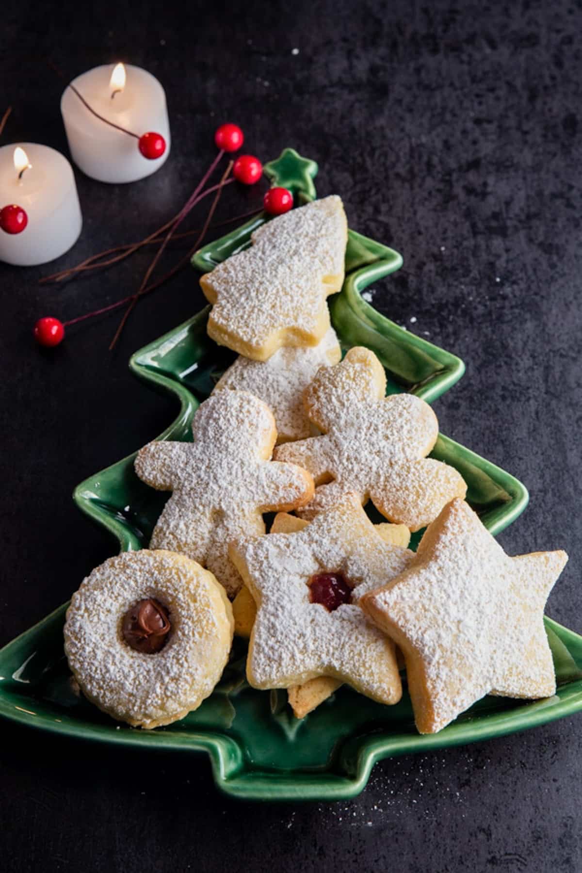 Italian Christmas cookies on a green Christmas tree dish.