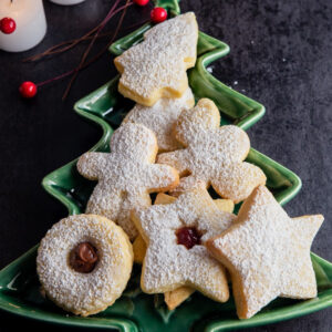 Italian Christmas cookies on a green Christmas tree dish.