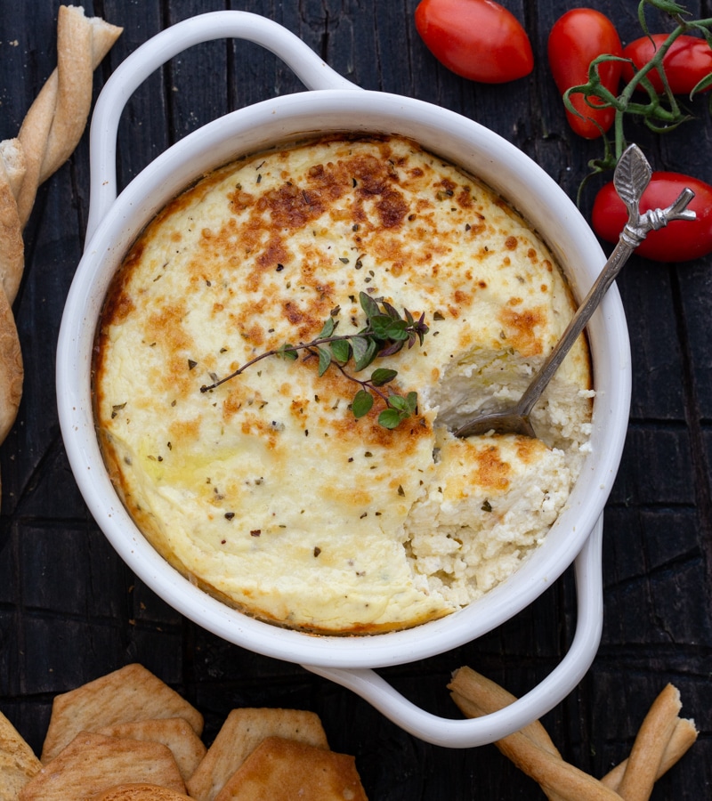 baked ricotta in a white baking dish with a spoon