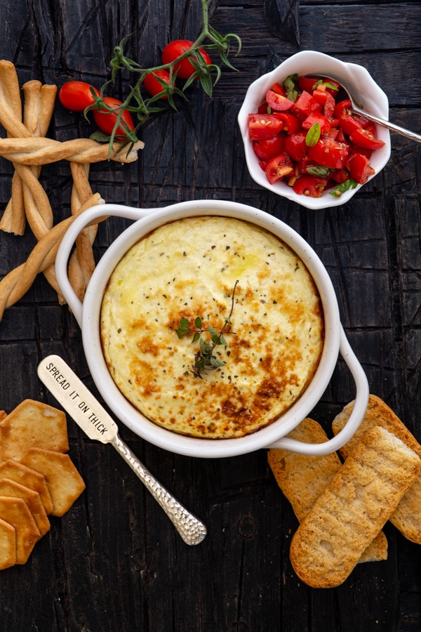baked ricotta in a white dish with cut up tomatoes