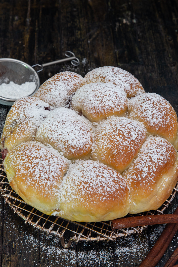 pull apart bread on a wire rack with powdered sugar