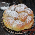 pull apart bread on a wire rack with powdered sugar