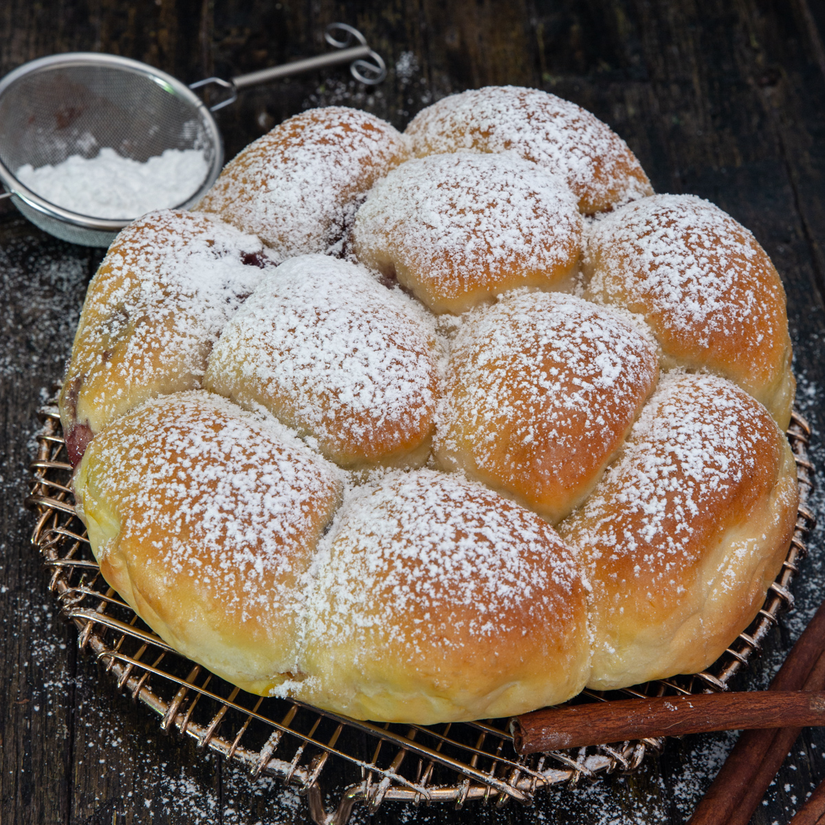 pull apart bread on a wire rack with powdered sugar
